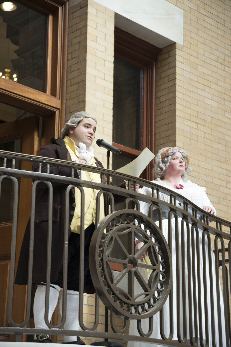 Man and woman standing on balcony in government building